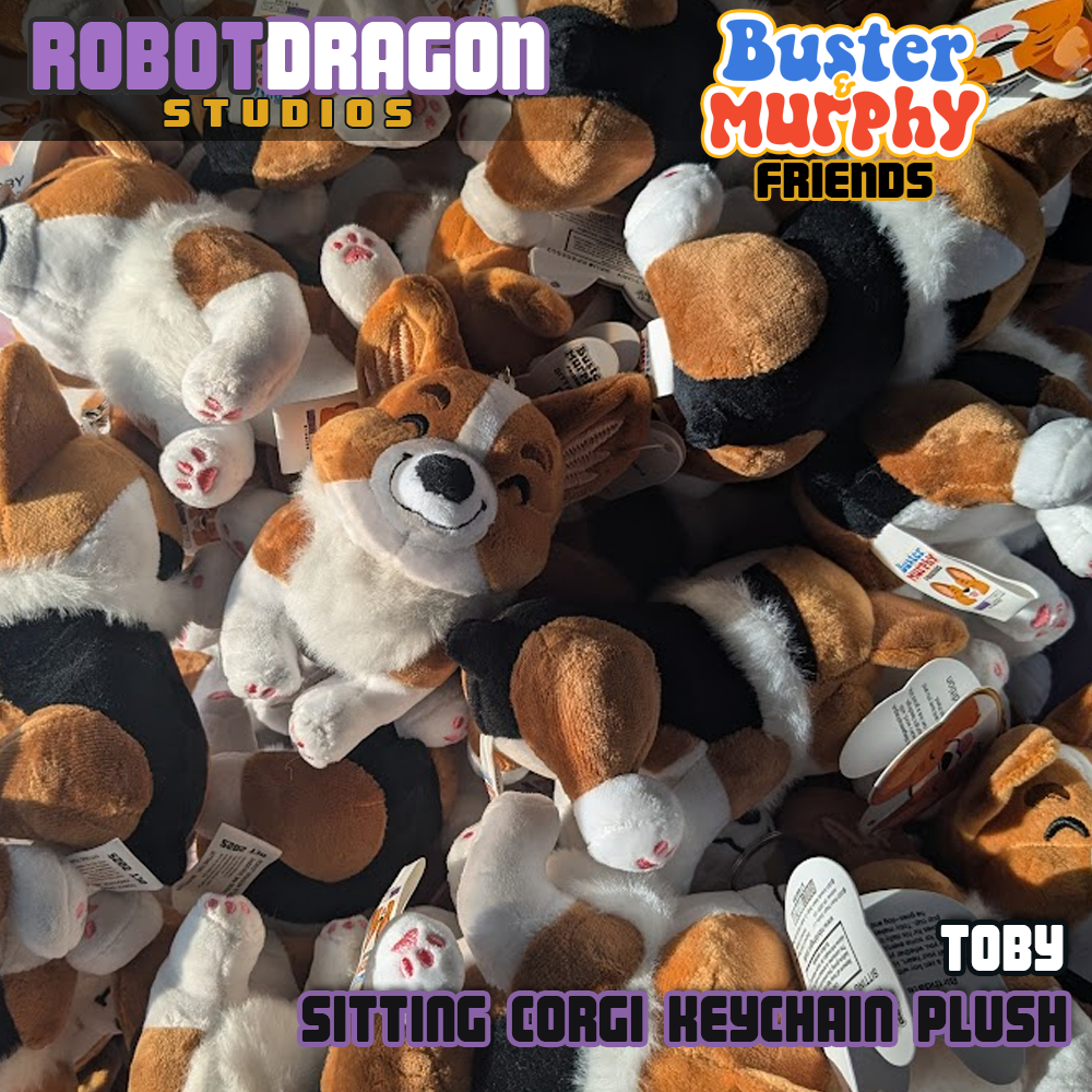 Pile of limited edition Toby red-headed tricolor corgi keychains designed and created by Robot Dragon Studios.