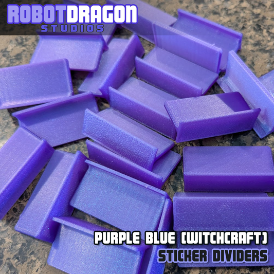 Close up photo of a messy pile of 3D printed purple blue iridescent PETG sticker dividers designed and created by Robot Dragon Studios for artist alley.