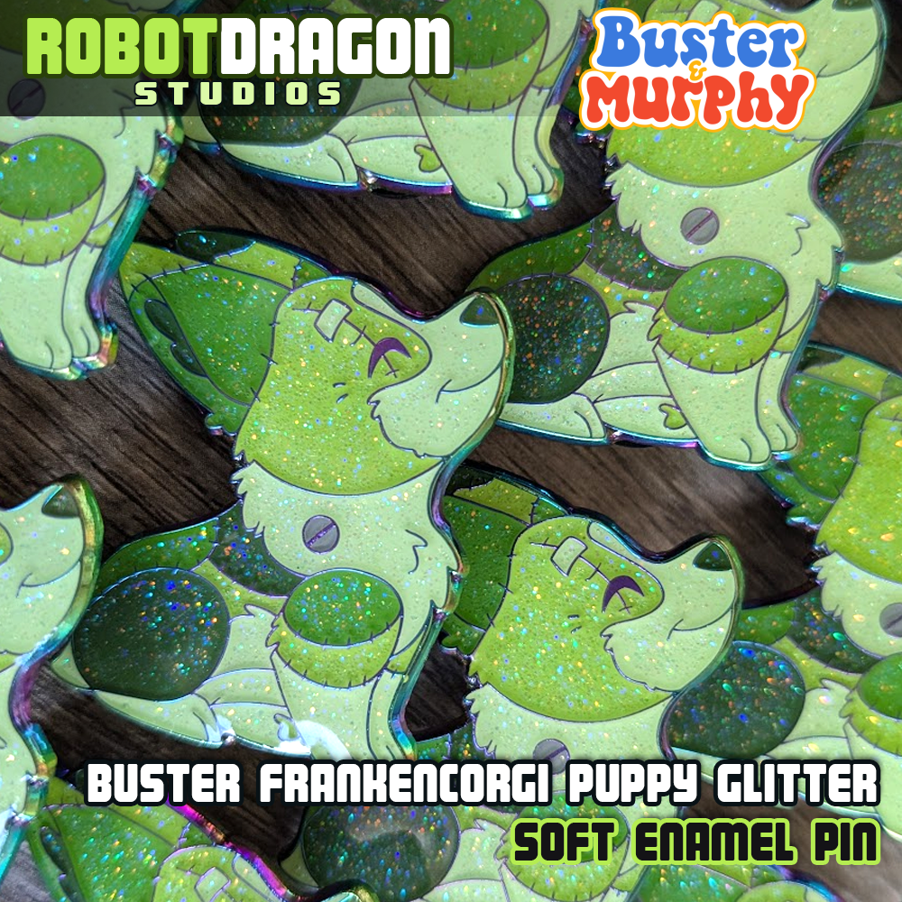 Close up photo of several Buster Frankencorgi puppy enamel pins with rainbow metal finish and glitter effects by Robot Dragon Studios.