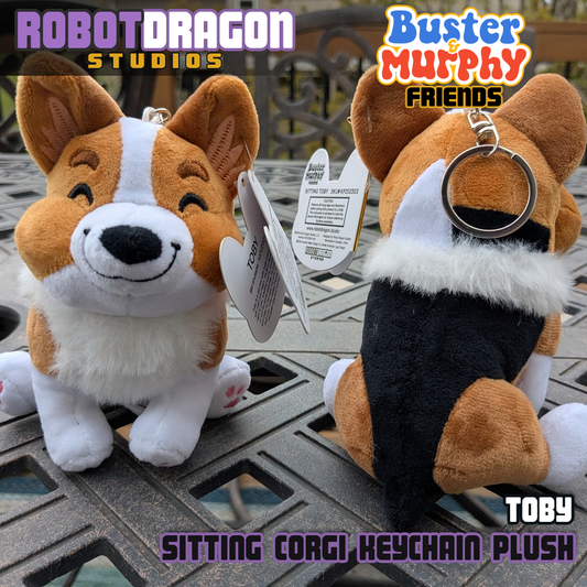 Front and back closeup of two limited edition Toby red-headed tricolor corgi keychains designed and created by Robot Dragon Studios.