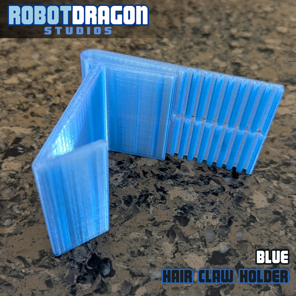 Angled profile of a 3D printed blue translucent PETG hair claw holder designed and created by Robot Dragon Studios for artist alley.