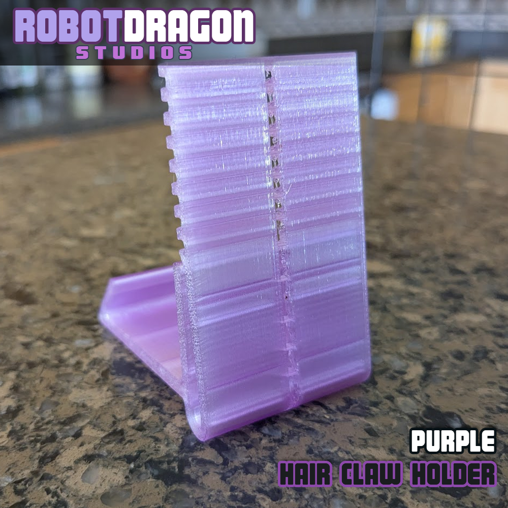 Back closeup photo of a 3D printed purple translucent PETG hair claw holder designed and created by Robot Dragon Studios for artist alley.