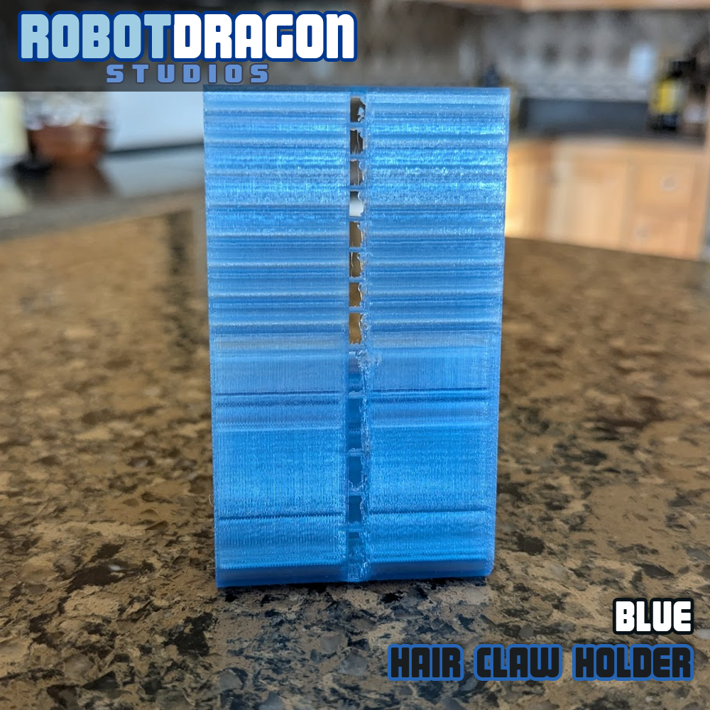 Backside of a 3D printed blue translucent PETG hair claw holder designed and created by Robot Dragon Studios for artist alley.