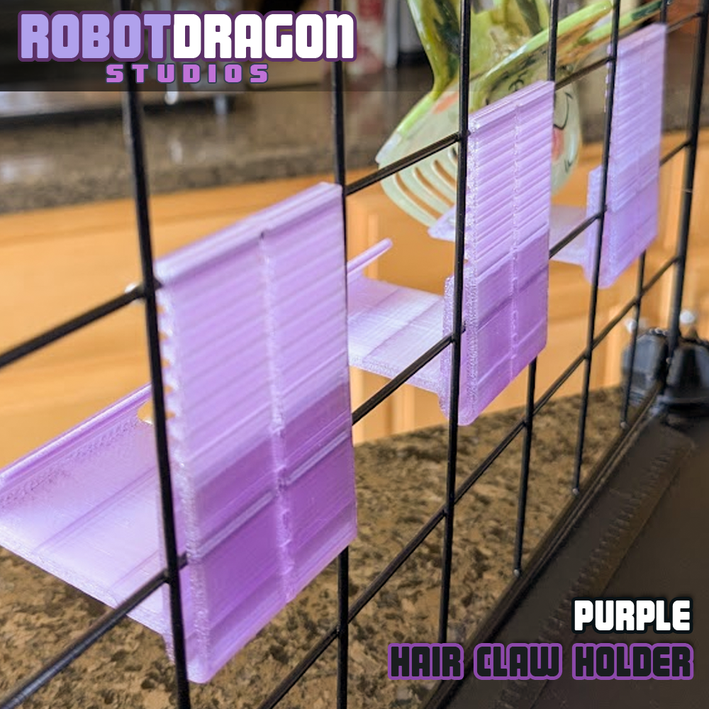 Backside photo of three 3D printed purple translucent PETG hair claw holders designed and created by Robot Dragon Studios on a wire grid cube setup for artist alley.