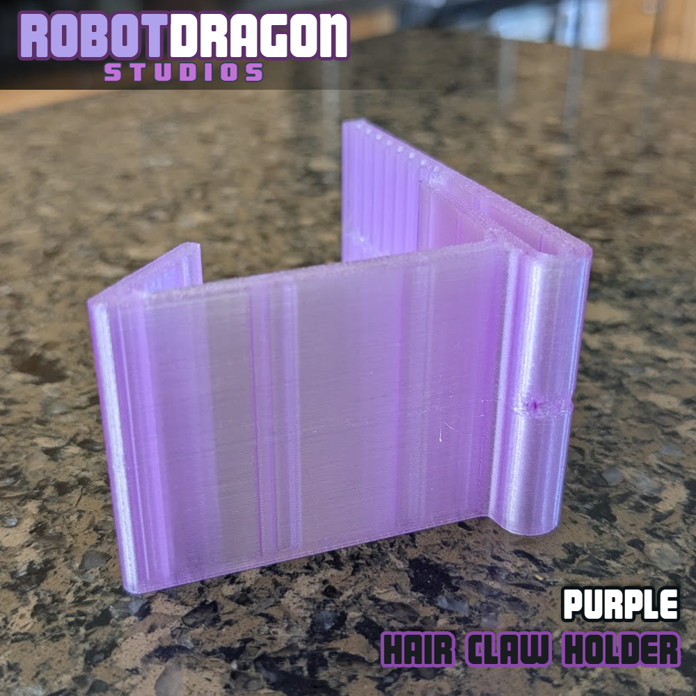 Bottom closeup photo of a 3D printed purple translucent PETG hair claw holder designed and created by Robot Dragon Studios for artist alley.