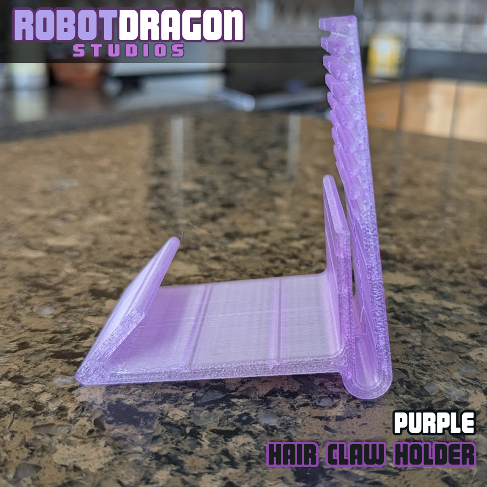 Profile closeup photo of a 3D printed purple translucent PETG hair claw holder designed and created by Robot Dragon Studios for artist alley.