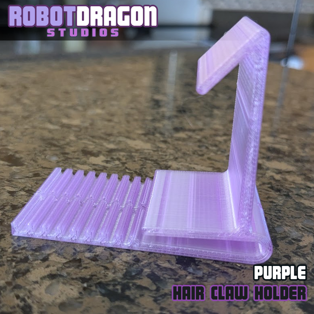 Sideview closeup photo of a 3D printed purple translucent PETG hair claw holder designed and created by Robot Dragon Studios for artist alley.
