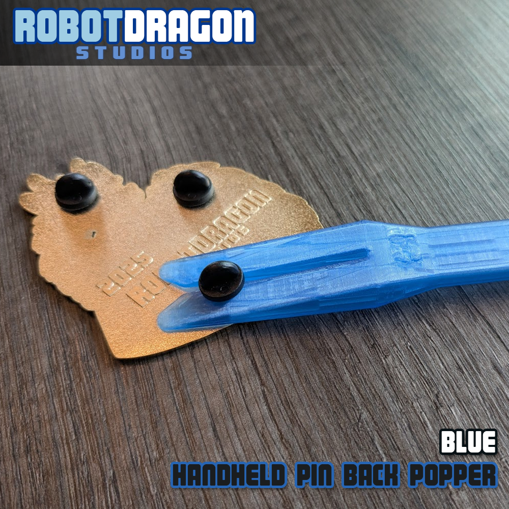 Blue 3D printed handheld enamel pin pin-back popper from Robot Dragon Studios