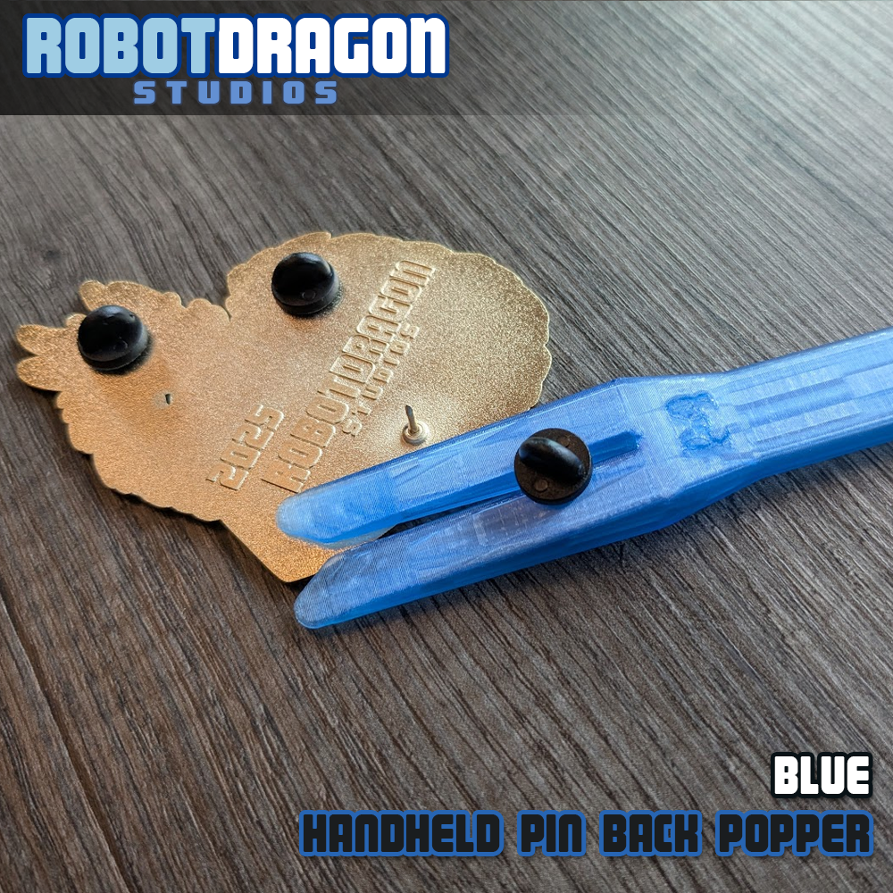 Blue 3D printed handheld enamel pin pin-back popper from Robot Dragon Studios