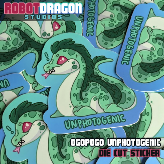 Pile of die cut Ogopogo Unphotogenic stickers from Robot Dragon Studios.