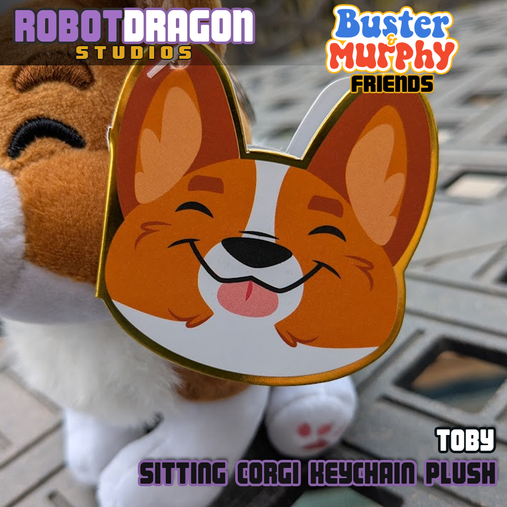 Closeup of the limited edition Toby red-headed tricolor corgi keychain tag designed and created by Robot Dragon Studios.