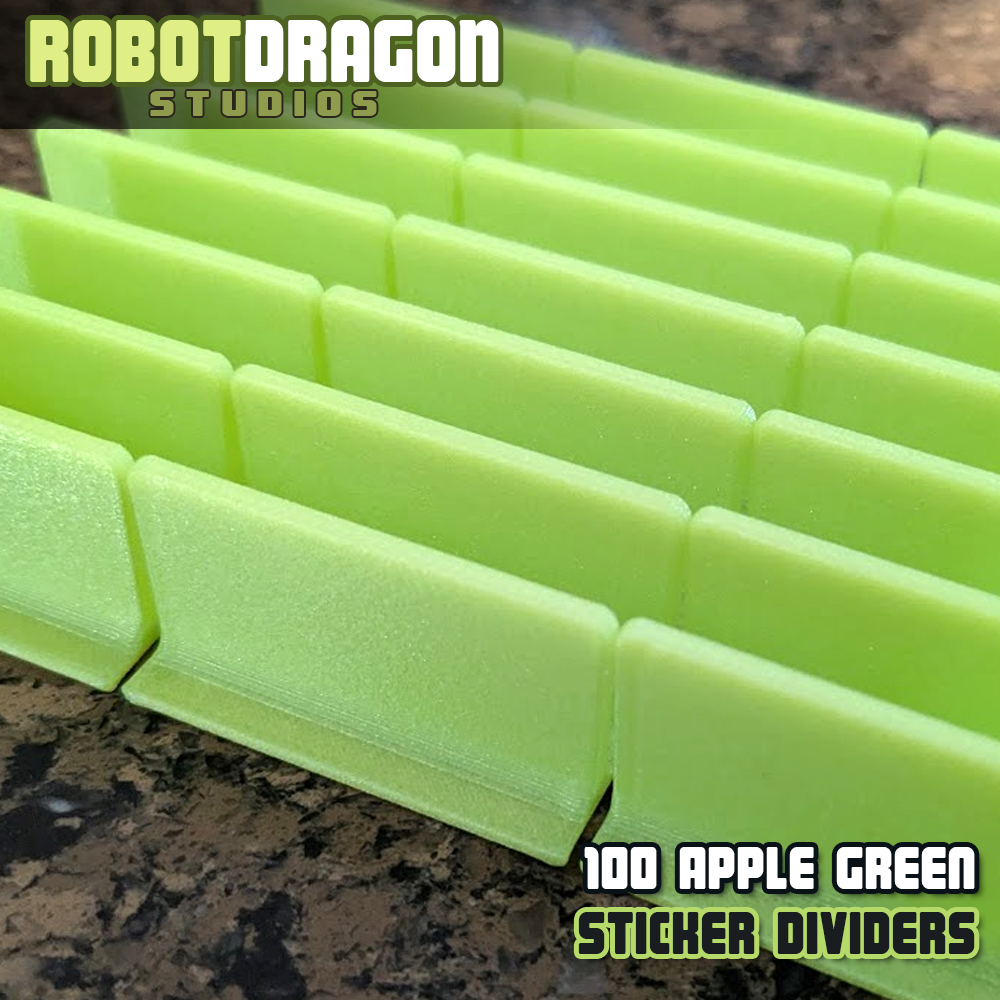Close up photo of a row of 3D printed apple green iridescent PETG sticker dividers designed and created by Robot Dragon Studios for artist alley.