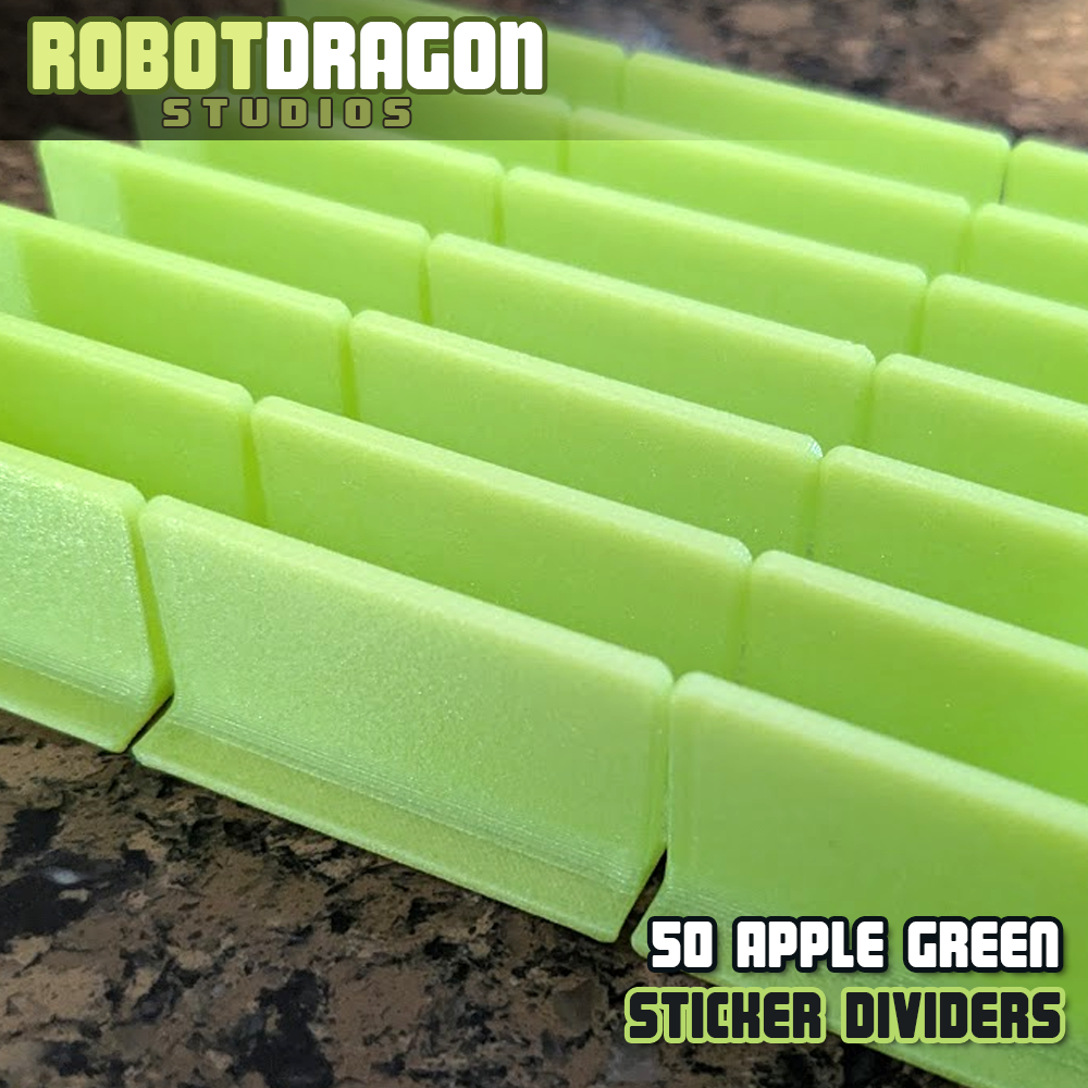 Close up photo of a row of 3D printed apple green iridescent PETG sticker dividers designed and created by Robot Dragon Studios for artist alley.