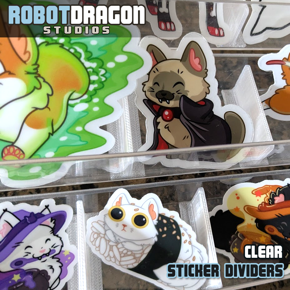 Example of 3D printed clear translucent PETG sticker dividers in use in a sticker display designed and created by Robot Dragon Studios for artist alley, also visible are Portal Buster, Vampire Cat, Witch Kitty, Sushi cat, and other original character designs.