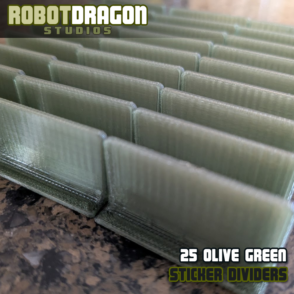 Close up photo of a row of 3D printed olive green translucent PETG sticker dividers designed and created by Robot Dragon Studios for artist alley.