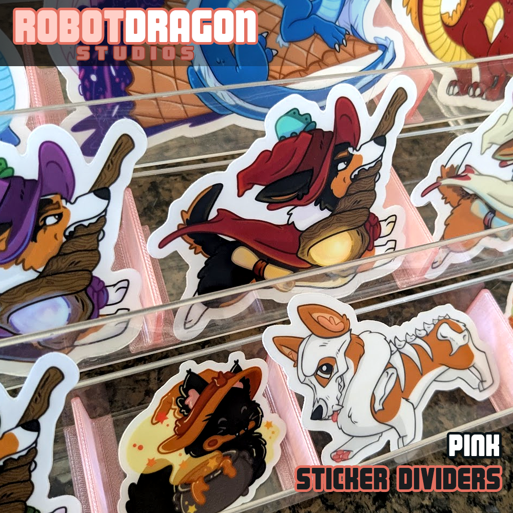 Example of 3D printed pink translucent PETG sticker dividers in use in a sticker display designed and created by Robot Dragon Studios for artist alley, also visible are Wizard Corgi, Nebula with Ice Cream, Cinder Witch Kitty, and Buster Bone Corgi.