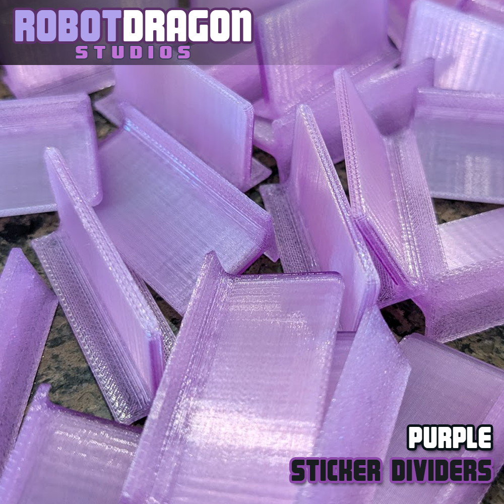 Close up photo of a messy pile of 3D printed purple translucent PETG sticker dividers designed and created by Robot Dragon Studios for artist alley.