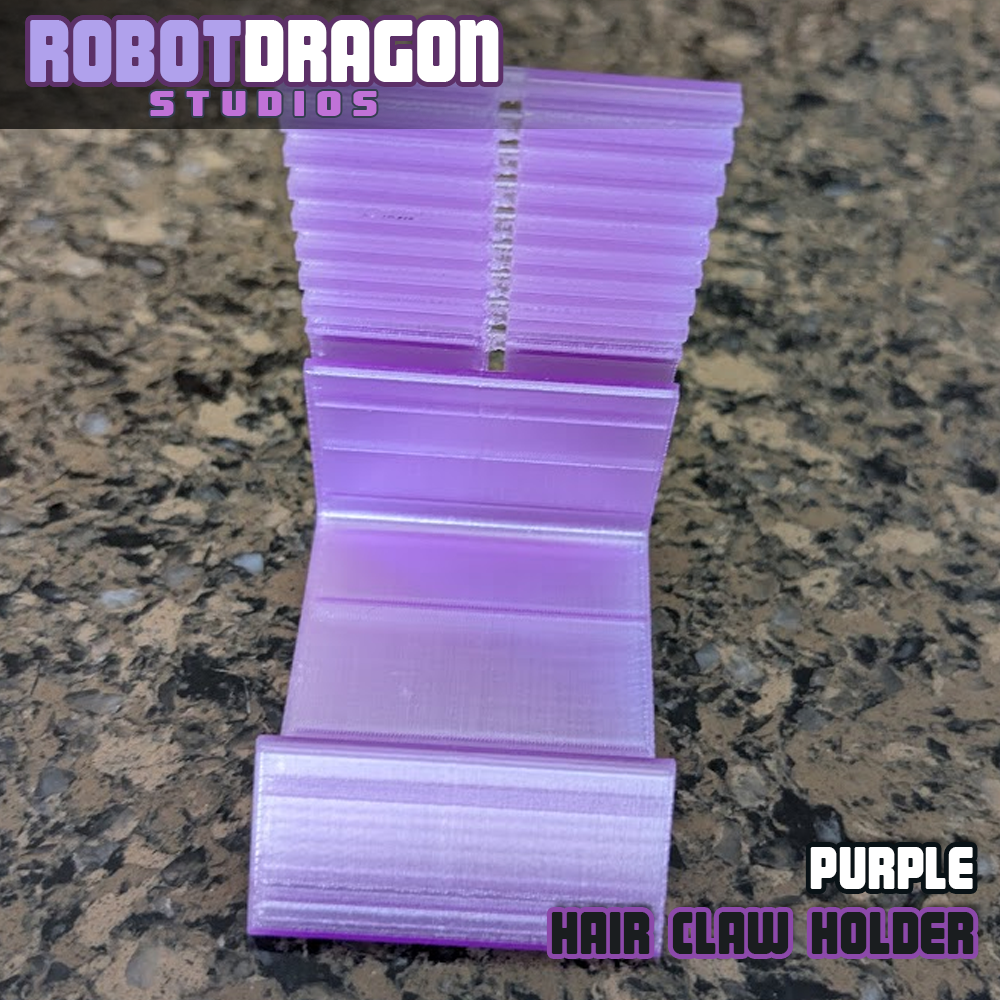 Top front closeup photo of a 3D printed purple translucent PETG hair claw holder designed and created by Robot Dragon Studios for artist alley.