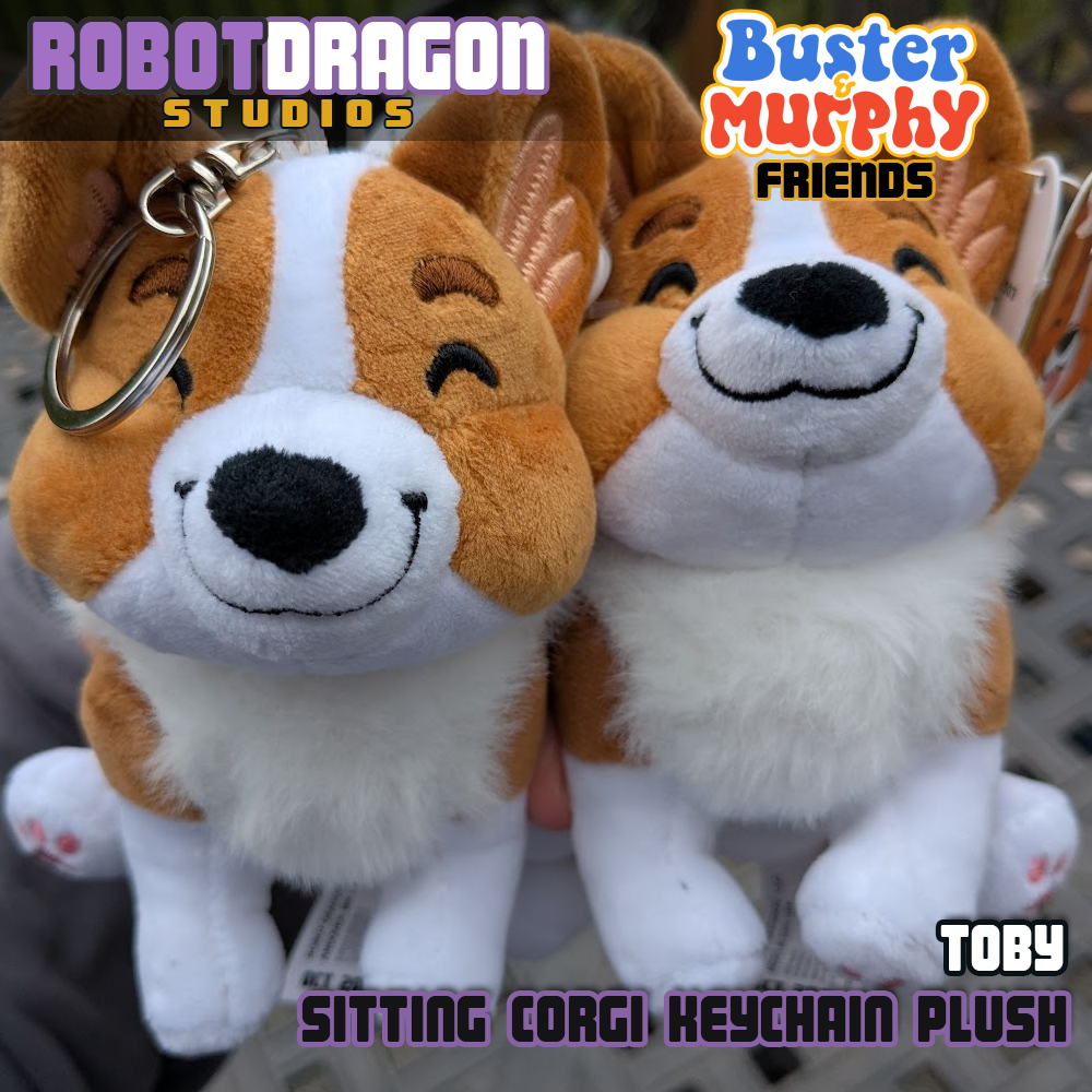 Closeup of two limited edition Toby red-headed tricolor corgi keychains designed and created by Robot Dragon Studios.